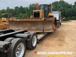 Large bulldozer on a specialized heavy-haul lowboy trailer.